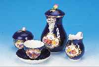 Mokkaservice, Meissen, 60er Jahre, 1. Wahl, Porzellan, kobaltblau glasiert, in goldgerahm-ten Kartuschen feine bunte Blumenmalerei, H. Kanne ca. ...