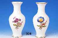 Zwei Vasen, Meissen, 20. Jh., Porzellan, bunte Bemalung, Blumenbouquet u. Streublm- chen, Goldrand, H. ca. 24 cm, min. ber.