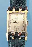 ELGIN HERRENARMBANDUHR MODELL DELUXE, REF.- NR. 316184/5526, USA UM 1952, GG-FILLED, BODENGEDR., IN SICH GEW., 2-FARB. VERS. ORIG.-BLATTKL. SEK. ...