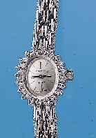 ZENITH DAMENGOLDBANDUHR, NEUTR. WG 750/000- OVAL-GEH. INCL. WG-BAND RHOD., LüNETTE M. 20 BRILLANTEN ZUS. CA. 0,3 CT L. GET. WEIß, BO- DEN GEDR., ...