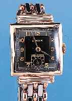 BENRUS HERRENARMBANDUHR, REF.-NR. 313726, SCHWEIZ UM 1950, METALL ROTVERG., EDELST.-BO- DEN GEDR., ZEITIDENT. METALLBAND M. EDELST.- FALTSCHL., ...