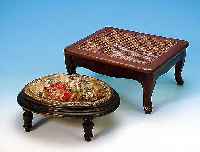 Zwei Hocker, deutsch, um 1890-1900, 1 x Holz schwarz gefaßt, mit Petit-Point-Stickereica. 13 x 34 x 26 cm; 1 x Buche mit geflochte- ner ...