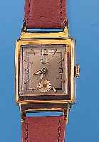 GUB Herrenarmbanduhr, Metallgeh. hartverg., altersbed. ber., Edelst.-Bod. aufgedr., außer Krone, Glas u. Lederbd. Orig.-Zustand um 1955,2 farb. ...