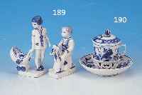 ZWEI PORZELLANFIGUREN, BING & GRöHNDAHL, 30ER J., BLAUE BEMALUNG: 1 X KIND AUF SCHAUKEL- PFERD, H. CA. 12,5 CM; 1 X MäDCHEN MIT PUPPEN-WAGEN, H. ...