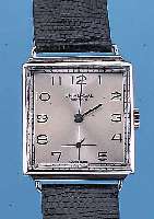 UNIVERSAL GENEVE HERRENARMBANDUHR, REF.-NR. 21020, SCHWEIZ UM 1946, EDELST.-CARREE-GEH., BODEN GEDR., ZU DEN BANDANST. REP., BOMB. MI- NERALGL., ...