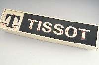TISSOT WERBESCHILD, WOHL 70ER JAHRE, ELEK- TRIFIZIERT, NOCH ALTER STECKER OHNE ERDUNG, BELEUCHTBAR, FUNKTION NICHT GEPRüFT, M. CA. 12 X 63,5 X ...
