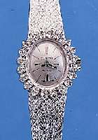 ZENITH DAMENGOLDBANDUHR, SCHWEIZ UM 1970, NEUTR. WG 750/000-GEH. INCL. WG-FLECHTBAND, RODH., OVALLüNETTE AUFWEND. M. 20 8/8 DIAMAN- TEN ZUS. ...