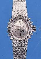 ZENITH DAMENGOLDBANDUHR, SCHWEIZ UM 1970, NEUTR. WG 750/000-GEH. INCL. WG-FLECHTBAND, LüNETTE AUFWEND. M. 20 8/8 DIAMANTEN ZUS. CA. ZUS. CA. ...