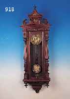 WANDUHR, GUSTAV BECKER, UM 1900, REICH VER- ZIERTES UND GESCHNITZTES HOLZGEHäUSE, MESSINGAPPLIKATIONEN, ORIGINALAUFSATZ, DREI- SEITIG ...