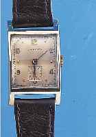LONGINES HERRENARMBANDUHR, 14 KT GG-GEH., RECTANG-FORM, BOD. AUFGEDR., KONKAVGL. 4- FLäCHIG, ALTERSBED. BERIEB. VERS. ORIG.-BLATT,KL. SEK. ...