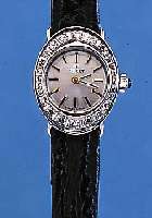 TISSOT DAMENARMBANDUHR, SCHWEIZ UM 1970, NEUTR. WG 585/000-GEH. M. HALBVERD. BANDANST.,LüNETTE AUFW. M. 8/8 DIAMANTEN ZUS. CA. 0,4 CT, ...