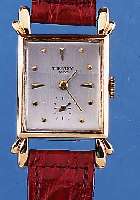TOURNEAU WATCH CO. HERRENARMBANDUHR, SCHWEIZ/USA UM 1945, GG 585/000, AUFWEND. RECT.-FORM M. BET. BANDANST., MINERALKONKAVGL.M. L. ...