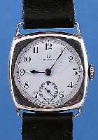 OMEGA HERRENARMBANDUHR, REF.-NR. 6142911, UM 1922, 900ER SILBER, CARREE-CAMBRE-FORM, BODEN U. GLASR. GEDR., ORIG.-BLATT SIGN., FEINHAARR., ...