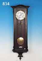 WANDUHR, GUSTAV BECKER, UM 1880, HOLZGEHäU- SE, BEKRöNUNGEN FEHLEN, SEK. GELACKT, DREI- SEITIG VERGLAST, ZWEIGETEILTES EMAILZIFFER- BLATT MIT ...