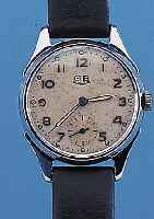 GUB HERRENARMBANDUHR, REF.-NR. 92828, DEUTSCHLAND UM 1952, METALL NACHVERCHR., EDELST.-BODEN U. GLASR. GEDR., ORIG.-BLATT ALTERSBED. ...