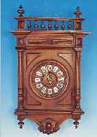 WANDUHR, FRANKREICH, UM 1870/80, VERZIERTES UND GESCHNITZTES HOLZGEHäUSE IM SOG. HENRI II-STIL, GEDREHTES HOLZZIFFERBLATT MIT EMAIL- KARTUSCHEN, ...