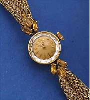 BAUME & MERCIER DAMENSCHMUCKBANDUHR, REF.- NR. 31672, SCHWEIZ UM 1966, GG 750/000 INCL. GG-BAND, GEFLOCHTEN ZU DEN M. TOPASEN BEL. BANDANST. ...