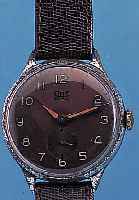 UMF/RUHLA HERRENARMBANDUHR, REF.-NR. 37/268/0004, DEUTSCHLAND UM 1955, METALL VERCHR., BERIEB., EDELST.-BOD. U. GLASR. ...