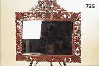 WANDSPIEGEL, FRANKREICH, UM 1900, RAHMEN EICHE, REICH GESCHNITZT UND DUNKEL GEBEIZT, FACETTIERTER GLASEINSATZ MIT LEICHTEN ALTERS- SPUREN, CA. ...