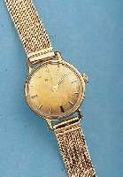 DUGENA DAMENARMBANDUHR, SCHWEIZ/DEUTSCHLAND UM 1964, METALL M. GG-AUFLAGE, EINSCHALENAUSF.NEUTR. ROSE-G. 585/000-FLECHTB., 17 ST., HAND-AUFZUGKAL. ...