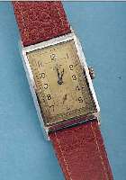 TISSOT HERRENARMBANDUHR, REF.-NR. 876189, SCHWEIZ UM 1936, METALL VERCHR., EDELST.- BODEN GEDR., GR. RECT.-FORM, MAßE CA. 43 X 25 MM, 2-FARB. ...