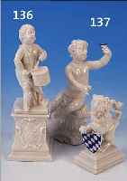 KONVOLUT ZWEI PORZELLANFIGUREN, 1 X FRANKEN-THAL, AUSFORMUNG NYMPHENBURG, PUTTO MIT BLU- MEN AUF ROCAILLENSOCKEL, H. 13 CM; 1 X NYM- PHENBURG, ...