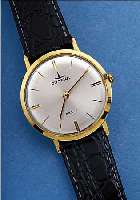 DUGENA HERRENARMBANDUHR FESTA, SCHWEIZ/ DEUTSCHL. UM 1962, GG 585/000, GLASRAND. AUF- GEDR., FLACHE GESAMTAUSFüHR., BLATT VERS., ...