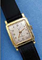 DUGENA HERRENARMBANDUHR FESTA, DEUTSCHL. UM1952, GG 585/000, BODEN AUFGEDR., BLATT ALTERSBED. FARBL. GETöNT, RUNDANKERWERK VON DUROWE, ...