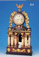 EMPIRE-UHR, WOHL WIEN/PRAG, UM 1820/1830, VERSCHIEDENE HöLZER, REICH MIT ZEITTYP. MESSINGAPPLIKATIONEN BESETZT (FIGUREN, ROCAILLEN, ...