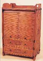 MODELLSCHRäNKCHEN, UM 1900, BUCHE MASSIV, MIT FLACHSCHNITZEREI, MIT 2 SCHüBEN (JE 2 KLEINE LEISTEN FEHLEN) UND ROLLTüR, FLACH- ...