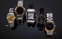 CARTIER HERRENARMBANDUHR SANTOS AUTOMATIK, SCHWEIZ UM 1980, EDELST., EINSCHALENGEH., GET.A-WELLE, BEI FERTIGST. WASSERD., EDELST.-BAND M. UNSICHTB. ...