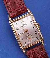 ELGIN HERRENARMBANDUHR DELUXE, USA UM 1948, GG-FILLED, RECT., BODEN GEDR., FORMANKERW., 17 ST., HANDAUFZUGKAL. 624, SCHR.-UNR., BREG.-SPIR., ...