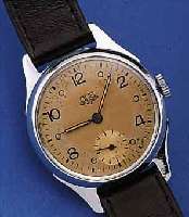 GUB HERRENARMBANDUHR, REF.-NR. 19473, DEUTSCHLAND UM 1953, METALLGEH. NACHVERCHR., EDELST.-BODEN U. GLASR. GEDR., ORIG.-BLATT FL., KAL. ...