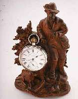 UHRENSTäNDER JäGER MIT HUND IN LANDSCHAFT, HOLZSCHNITZEREI, 2. HäLFTE 19. JAHRH., TEILW. BESCH., H. CA. 18 CM, M. TASCHENUHR, SIGN. MC CABE & ...