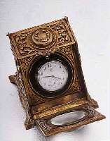 UHRENSTäNDER IN FORM EINER KOHLENSCHüTTE, MESSINGGUß, UM 1895, AUFKLAPPB., UHR M. HAL- TERUNG AUSSCHIEBB., LUPENVORSATZ, MAßE CA. 80 X 80 ...