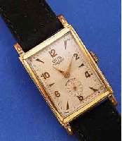 GUB HERRENARMBANDUHR, REF.-NR. 98725, DEUTSCHLAND UM 1958, METALL VERCHR., BER., EDELST.-BODEN GEDR., 2-FARB. VERS. ORIG.- BLATT, ...
