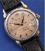 BULOVA HERRENARMBANDUHR AUTOMATIK, SCHWEIZ/ USA UM 1955, WG-FILLED, BODEN EDELST. GESCHR.,GUILL. U. VERS. BLATT, 23 ST., KAL. 10BPAC, SCHR.-UNR., ...