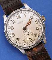 HOMIS WATCH/PRIMA HERRENARMBANDUHR, SCHWEIZ UM 1938, METALL VERN., BODEN U. GLASR. GEDR., ORIG.-ZUSTAND, D. CA. 37 MM, AUF BODEN WID- MUNGSGRAV. ...