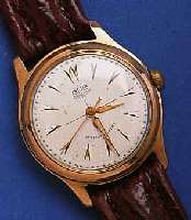 GUB HEGUB HERRENARMBANDUHR, SOGEN. GÜTEUHR, DEUTSCHLAND UM 1957, KAL. 60,3, ROTVERG., EDELST.-BODEN GESCHR., NUTZSP., BLATT M. GÜTEZEICHEN L. ...