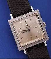 JULES JÜRGENSEN HERRENARMBANDUHR, SCHWEIZ/ USA UM 1965, GG 585/000, CARREE-GEH., LüNETTE GEST., KONKAVGL., BODEN GEDR., VERS. BLATT, 17 ST., ...