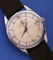 UNIVERSAL GENEVE HERRENARMBANDUHR AUTOMATIK POLEROUTER/DATE, EDELST., SCHWEIZ UM 1964, BODEN GESCHR., 28 ST., KAL. 69, GLYC.-UNR., FLACHSPIR., ...