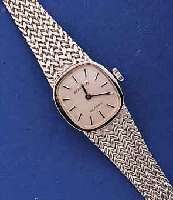 DUGENA DAMENGOLDBANDUHR, DEUTSCHLAND UM 1974, WG 585/000 INCL. WG-FEINGLIEDERBAND, BODEN GEDR., UNGETR. LAGERW., FORMANKERW. M. STAUBKONTAINER, 17 ...