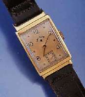 LORD ELGIN HERRENARMBANDUHR, USA UM 1952, 14 CT. GG, RECT.-FORM, MAßE CA. 35X20 MM, KONKAV-GL., BOD. AUFGEDR., IN SICH LT. GEWÖLBT , ORIG. BL. ...