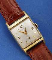 JULES JÜRGENSEN HERRENARMBANDUHR, SCHWEIZ/ USA UM 1954, GG-FILLED, RECT.-FORM, BOD. AUF- GEDR., ORIG. ETUI, LEDERBD. NEUTR. NEU, VERS. BL. ZUM ...