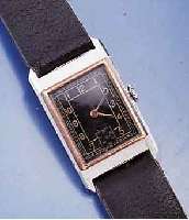 RECORD HERRENARMBANDUHR, SCHWEIZ UM 1937, EDELST.,RECT.-FORM, RG-LÜNETTE, MAßE CA. 38 X 22 MM, LEDERB. NEU, ORIG.-BLATT FL., BODEN GEDR., IN ...