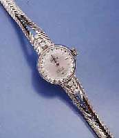 SANDOZ DAMENSCHMUCKBANDUHR, SCHWEIZ UM 1968, WG 750/000 INCL. 2-REIH. WG-GLIEDERB., RHOD., BANDANST. M. 6 DIAMANTEN BEL., BODEN GEDR., FORMANKERW., ...