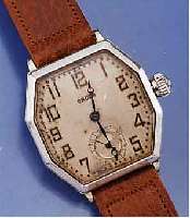 GRUEN FRÜHE HERRENARMBANDUHR, 585/000 WG- FILLED GEH., ACHTECKFORM, BOD. U. GLASRAND AUFGEDR., ORIG.-BLATT ALTERSBED. FARBL. GETÖNT, KL. SEK. ...