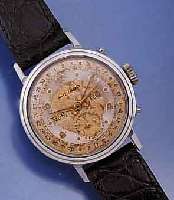 MOVADO HERRENARMBANDUHR M. VOLLKALENDERANZ., AUßER MONDPHASE, EDELST.-BOD. GESCHR., SCHWEIZ UM 1949, 2-FARB. VERS. BL., ALTERSBED. FLECKIG, ...