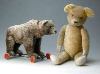 SteiffbÄr auf Rollen, 30er/40er Jahre, mit funktionierender Brummstimme, silbergrauer MohairplÜsch, Knopf im Ohr, Fahne fehlt, L. ca. 60 cm, ...