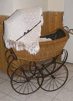 Kinder/Puppenwagen, deutsch, um 1910, geflochten, vier RÄder, Schirm im alten Stil, reich mit Stickereien verz., mit Kissen u. BezÜgen, teils ...